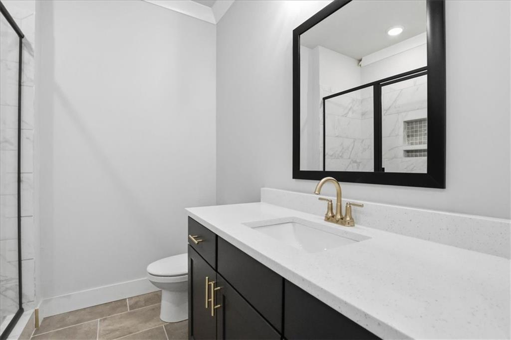 196 Red June Lane Clarkesville, GA 30523 - Photo 25 of 69 a bathroom with a sink a toilet and mirror