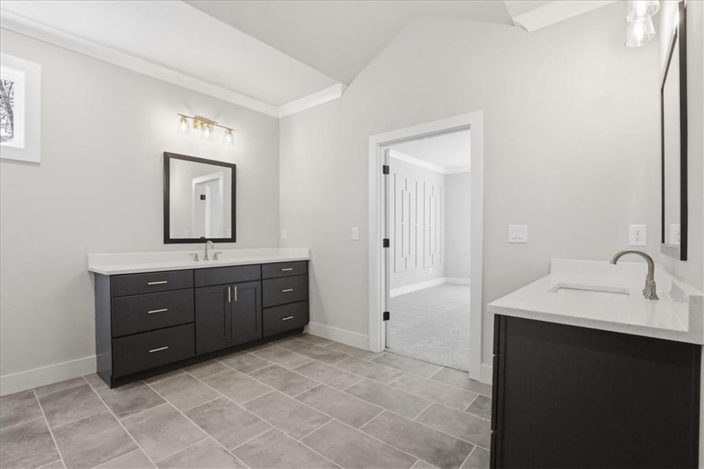 196 Red June Lane Clarkesville, GA 30523 - Photo 39 of 69 a spacious bathroom with a vanity a sink a mirror and a bathtub