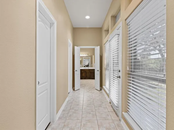 a spacious bathroom with a double vanity sink a large mirror and a shower