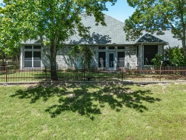 front view of a house with a yard and a street