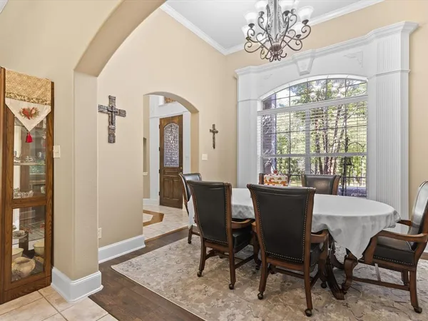 a dining room with furniture a chandelier and window