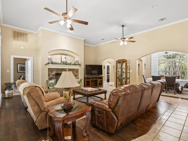 a living room with furniture a fireplace and a chandelier