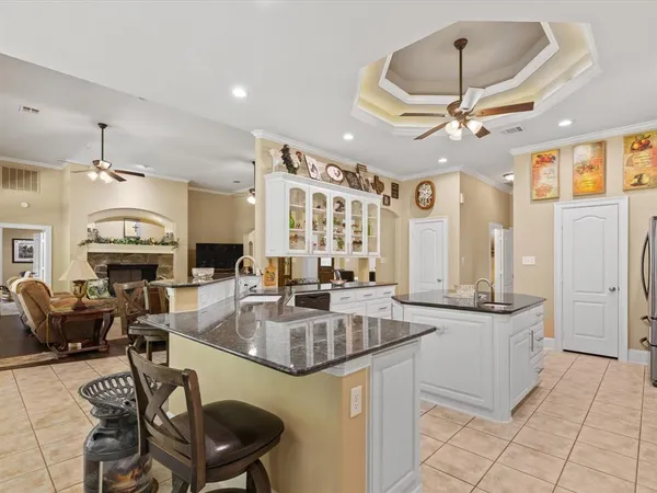 a kitchen with stainless steel appliances granite countertop a sink a stove and a refrigerator