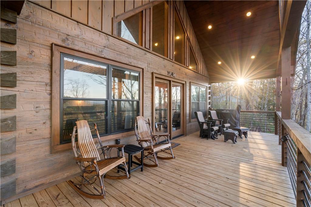 447 Pig Trail Cherry Log, GA 30522 - Photo 13 of 71 a view of a patio with table and chairs and wooden floor