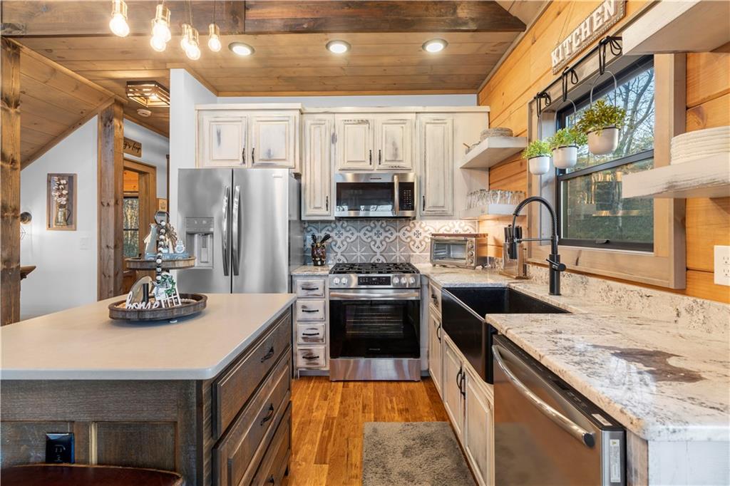 447 Pig Trail Cherry Log, GA 30522 - Photo 20 of 71 a kitchen with stainless steel appliances granite countertop a sink stove and refrigerator