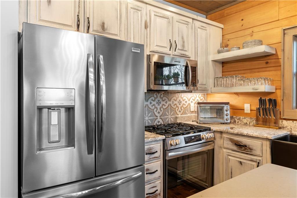 447 Pig Trail Cherry Log, GA 30522 - Photo 22 of 71 a kitchen with stainless steel appliances cabinets and a window