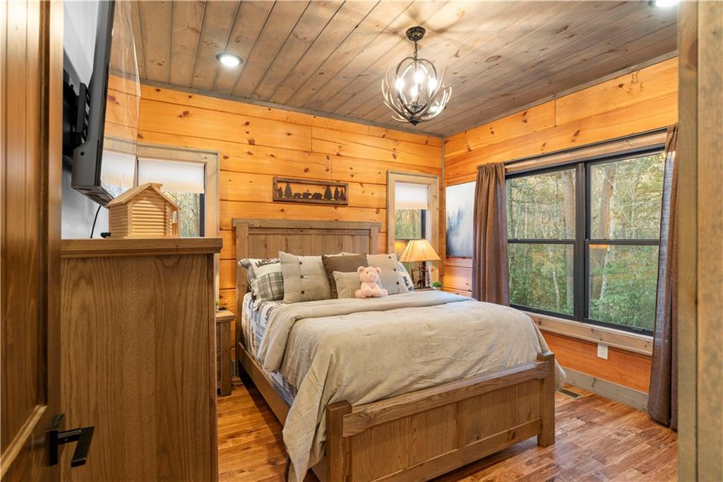447 Pig Trail Cherry Log, GA 30522 - Photo 25 of 71 a bedroom with a large bed and a window