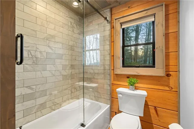 a bathroom with a double vanity sink toilet mirror and bathtub