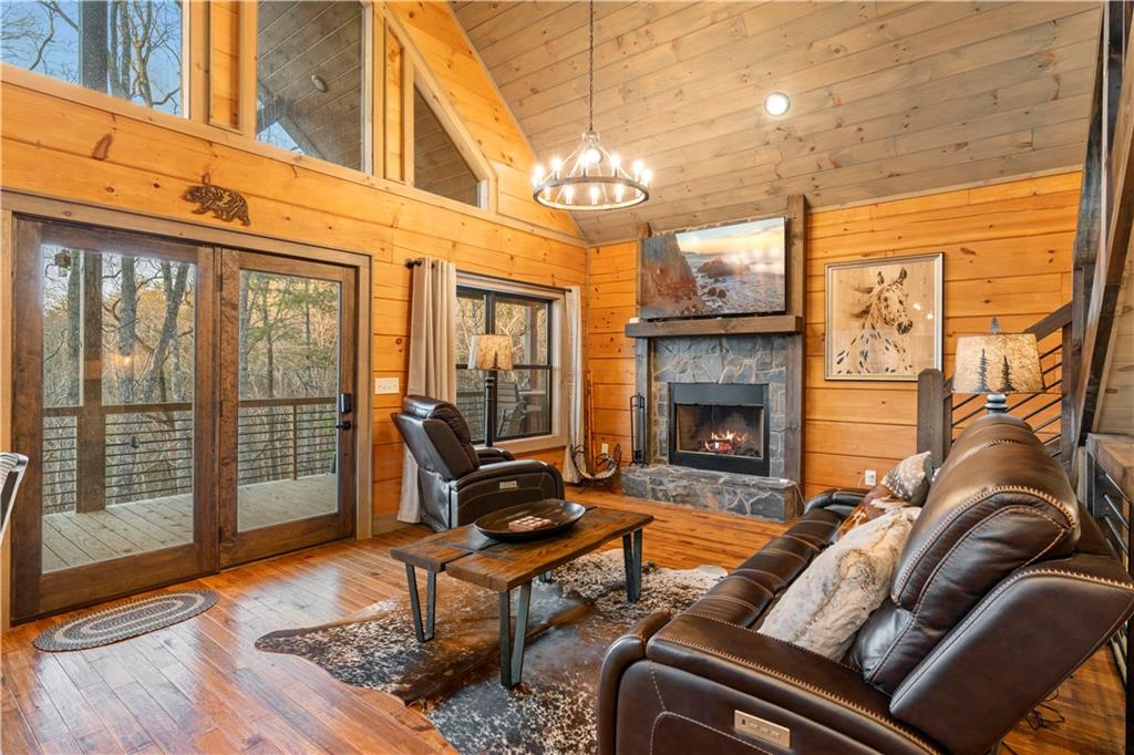 447 Pig Trail Cherry Log, GA 30522 - Photo 33 of 71 a living room with furniture a fireplace and a floor to ceiling window