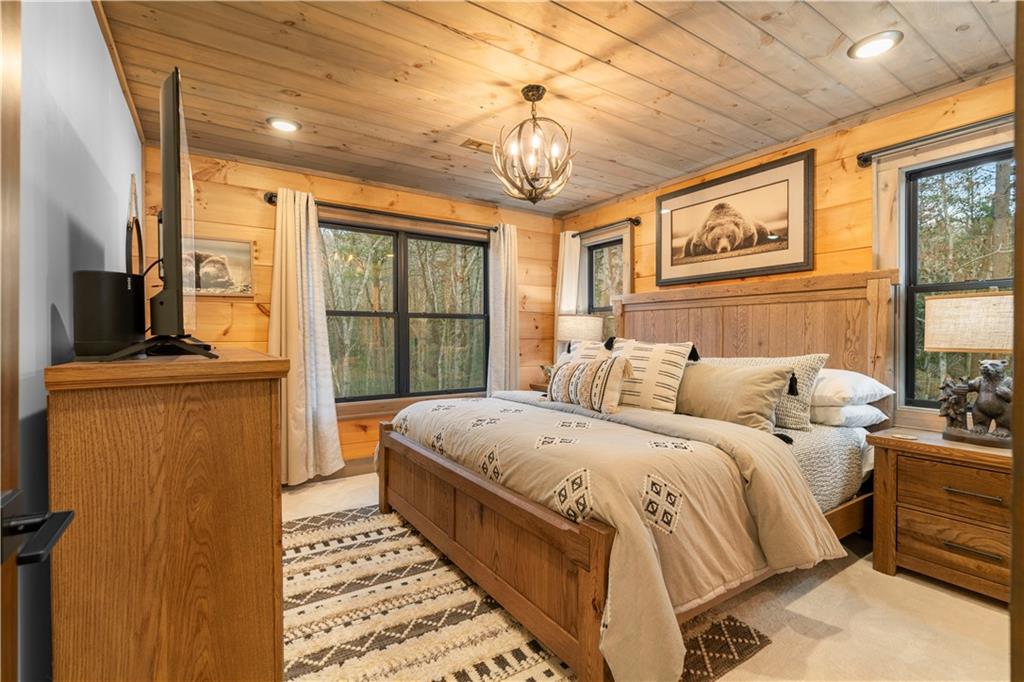 447 Pig Trail Cherry Log, GA 30522 - Photo 38 of 71 a bedroom with a bed a dresser next to a window
