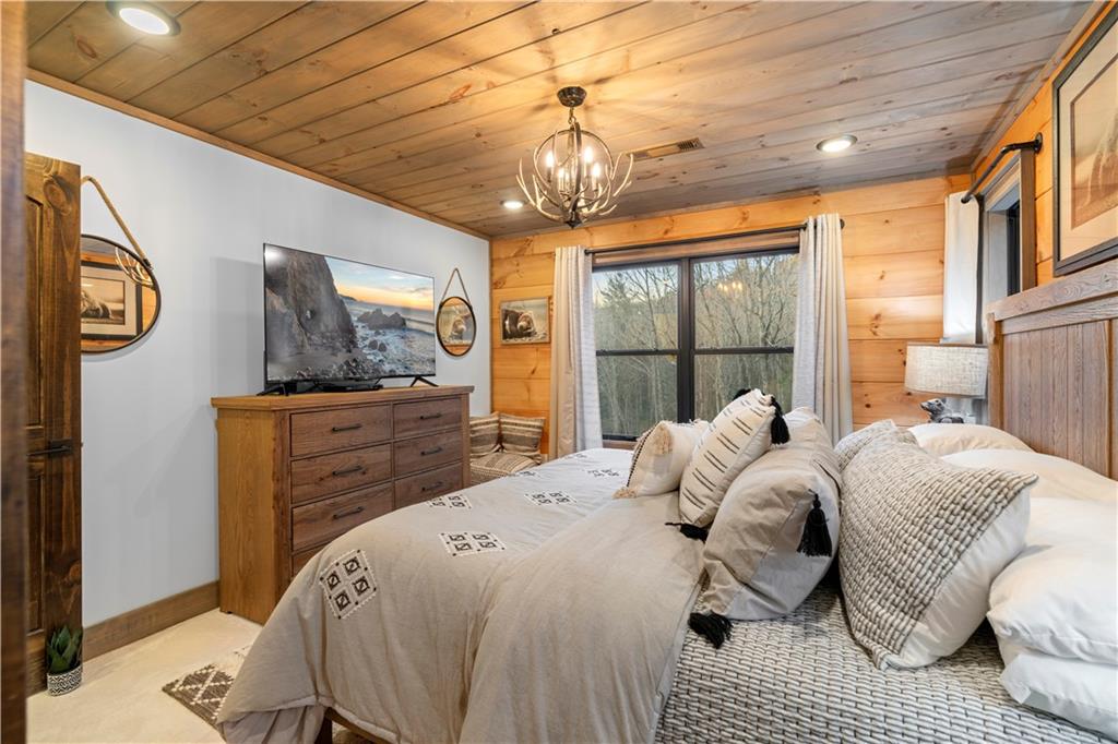 447 Pig Trail Cherry Log, GA 30522 - Photo 40 of 71 a bed sitting in a bedroom next to a window