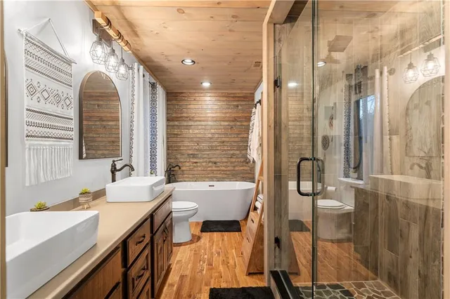 a bathroom with a sink a mirror and shower