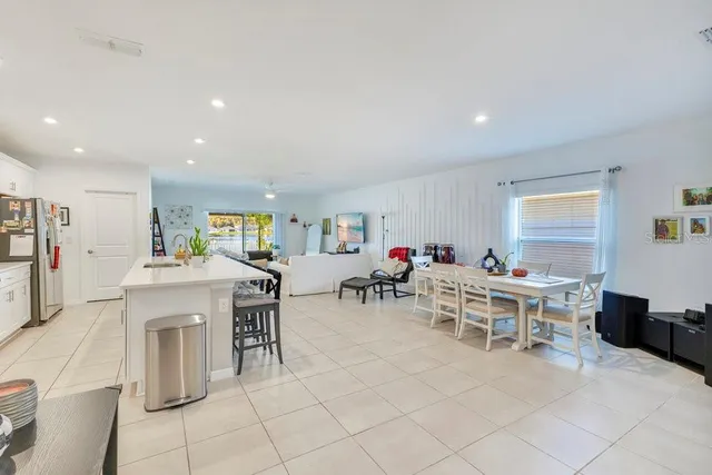 a living room with furniture a dining table and a fireplace