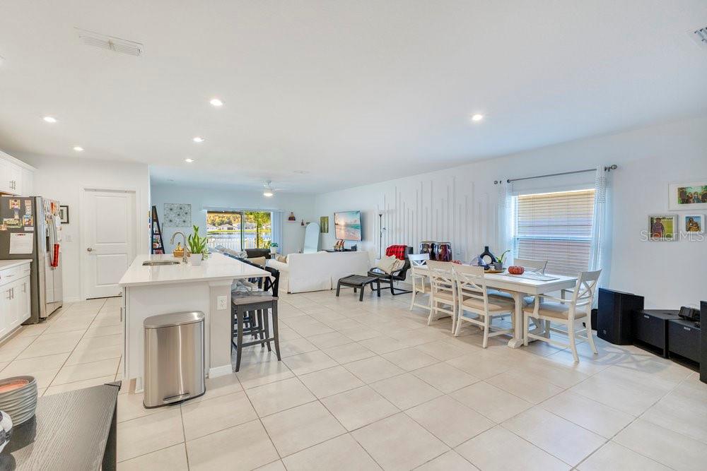 4255 Southern Vista Loop St. Cloud, FL 34772 - Photo 11 of 34 a living room with furniture a dining table and a fireplace