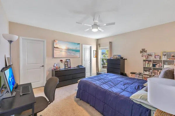 a bed room with a bed window and a chair
