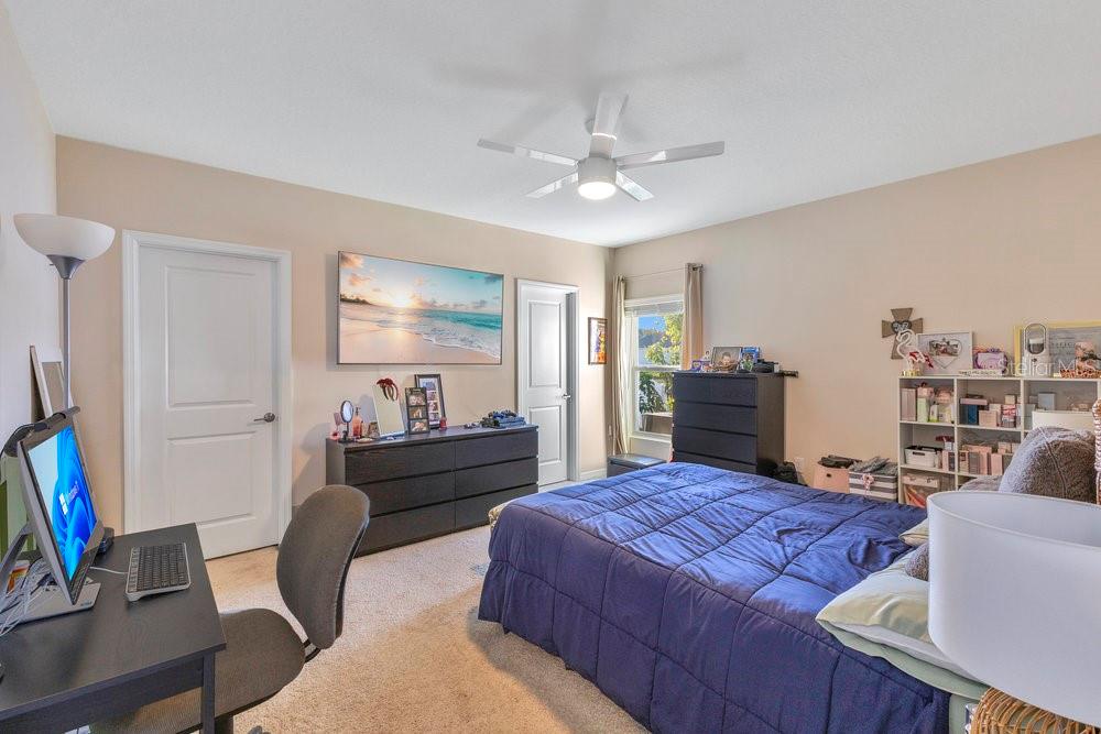 4255 Southern Vista Loop St. Cloud, FL 34772 - Photo 12 of 34 a bed room with a bed window and a chair