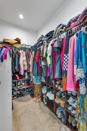 a view of walk in closet with clothes