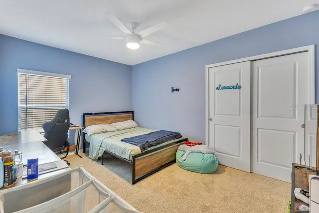 a bedroom with bed and a window