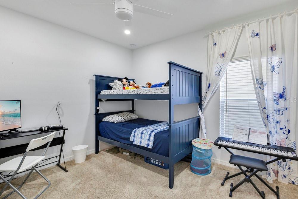 4255 Southern Vista Loop St. Cloud, FL 34772 - Photo 18 of 34 a bedroom with furniture and a window