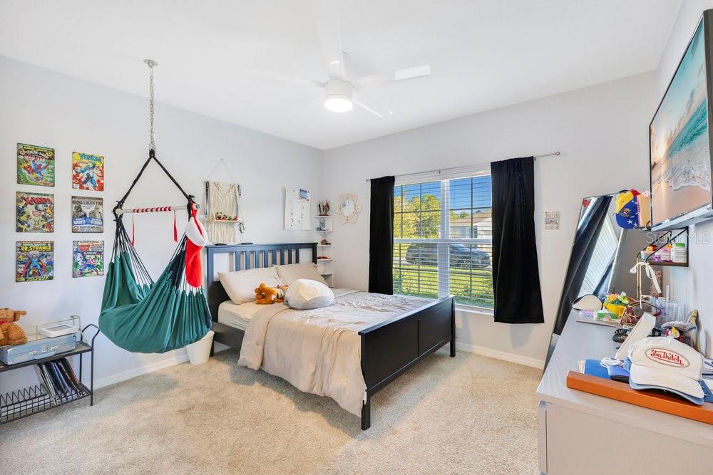 4255 Southern Vista Loop St. Cloud, FL 34772 - Photo 19 of 34 a living room with furniture and a flat screen tv