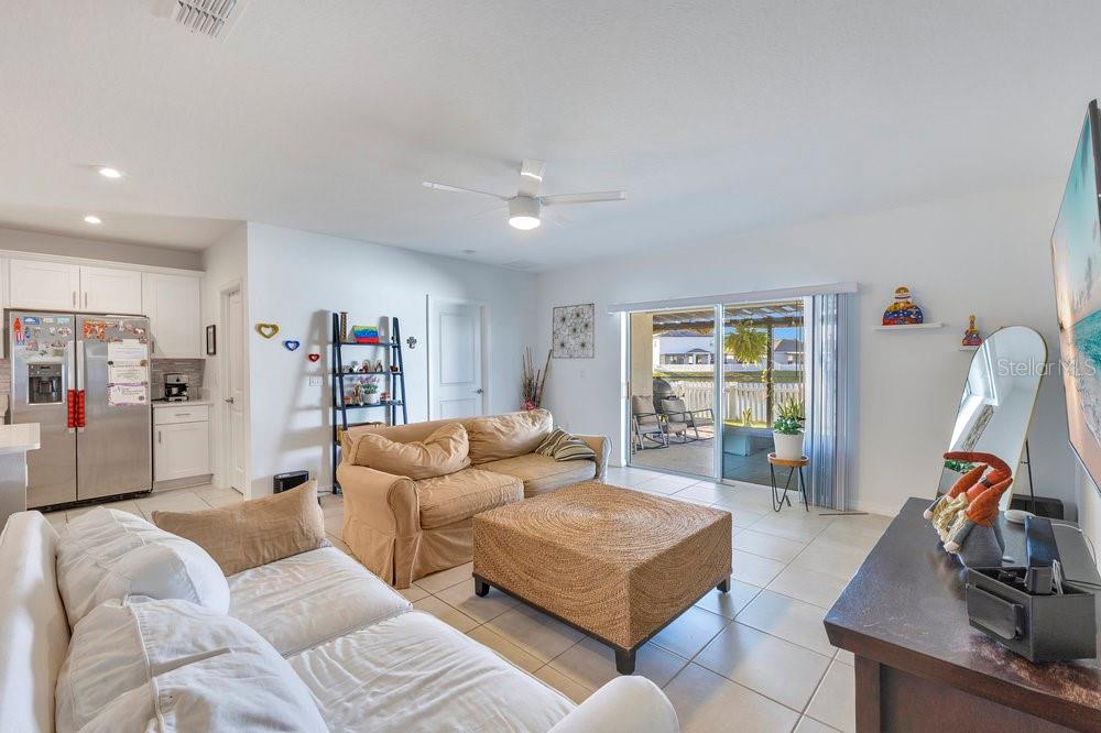 4255 Southern Vista Loop St. Cloud, FL 34772 - Photo 6 of 34 a living room with furniture and a flat screen tv