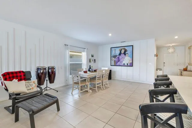 a living room with furniture a flat screen tv and a window