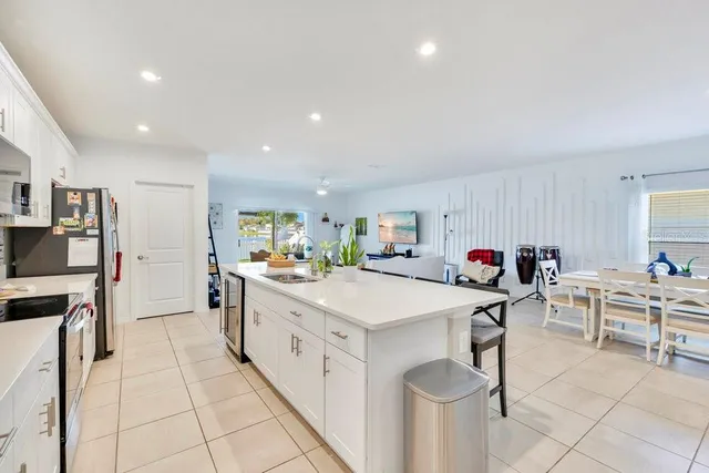 a kitchen with granite countertop a sink appliances and cabinets