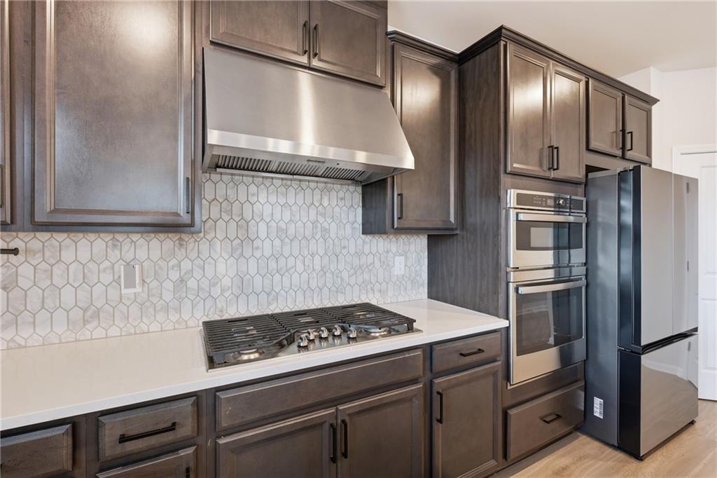 8820 Shipton Circle Ball Ground, GA 30107 - Photo 11 of 40 a kitchen with stainless steel appliances a stove and a refrigerator