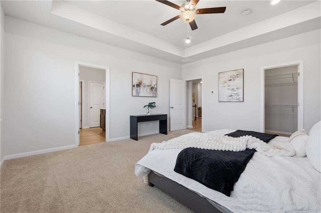 8820 Shipton Circle Ball Ground, GA 30107 - Photo 15 of 40 a bedroom with a large bed and ceiling fan