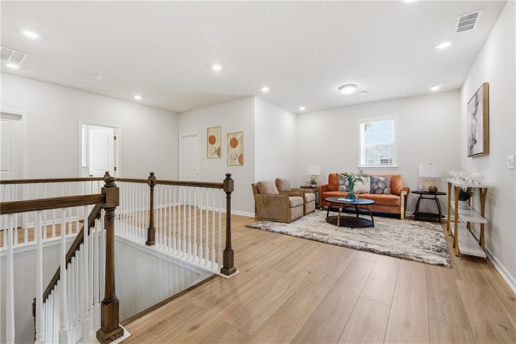 8820 Shipton Circle Ball Ground, GA 30107 - Photo 21 of 40 a living room with furniture and a wooden floor