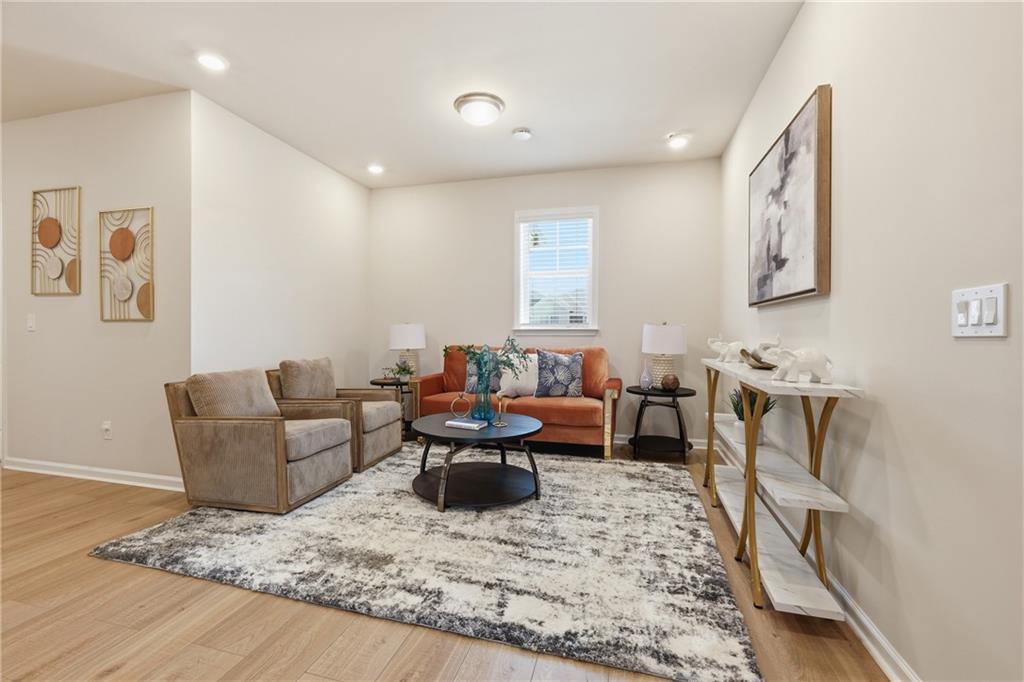 8820 Shipton Circle Ball Ground, GA 30107 - Photo 22 of 40 a living room with furniture and a rug
