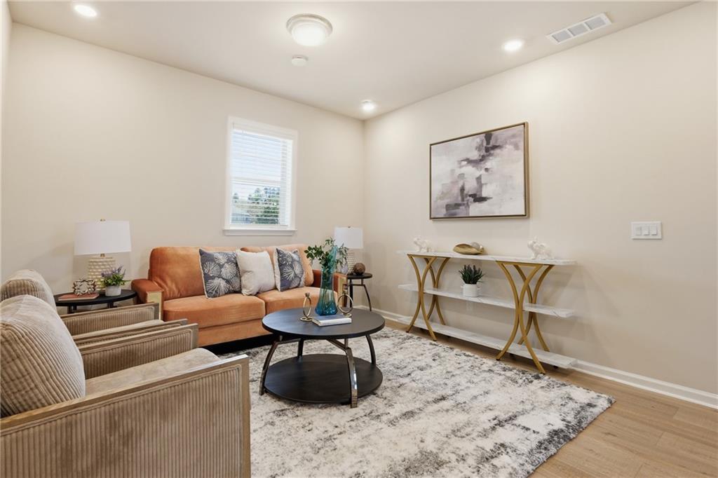 8820 Shipton Circle Ball Ground, GA 30107 - Photo 23 of 40 a living room with furniture and wooden floor