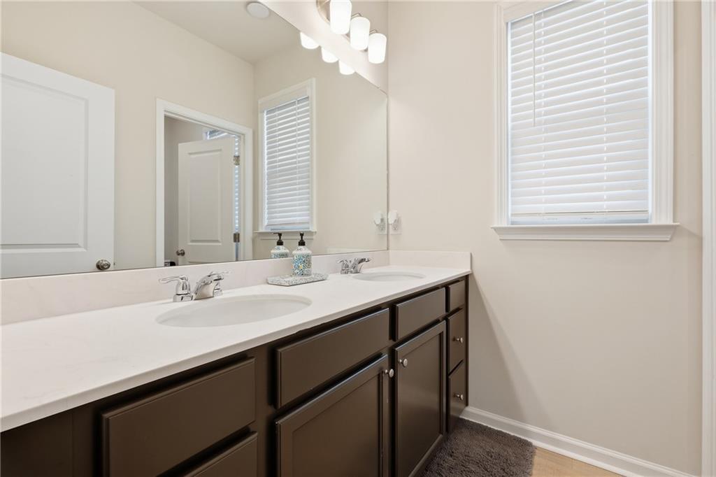 8820 Shipton Circle Ball Ground, GA 30107 - Photo 26 of 40 a bathroom with a sink a vanity and a mirror