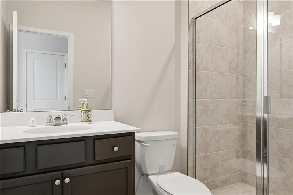 8820 Shipton Circle Ball Ground, GA 30107 - Photo 28 of 40 a bathroom with a sink a toilet and shower