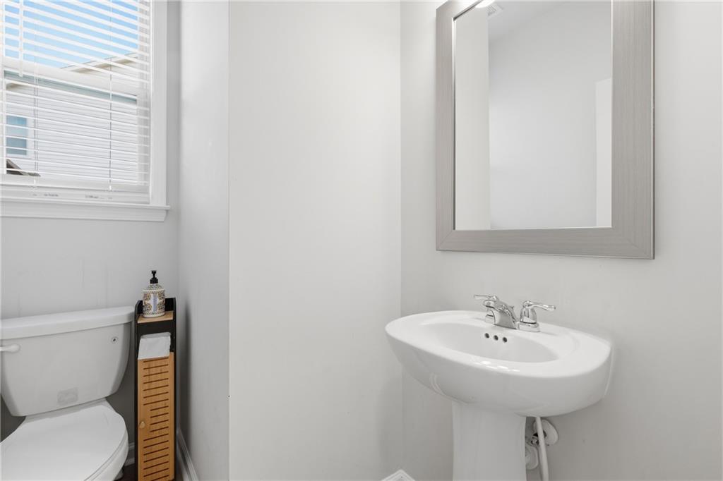 8820 Shipton Circle Ball Ground, GA 30107 - Photo 30 of 40 a bathroom with a sink a toilet and a mirror