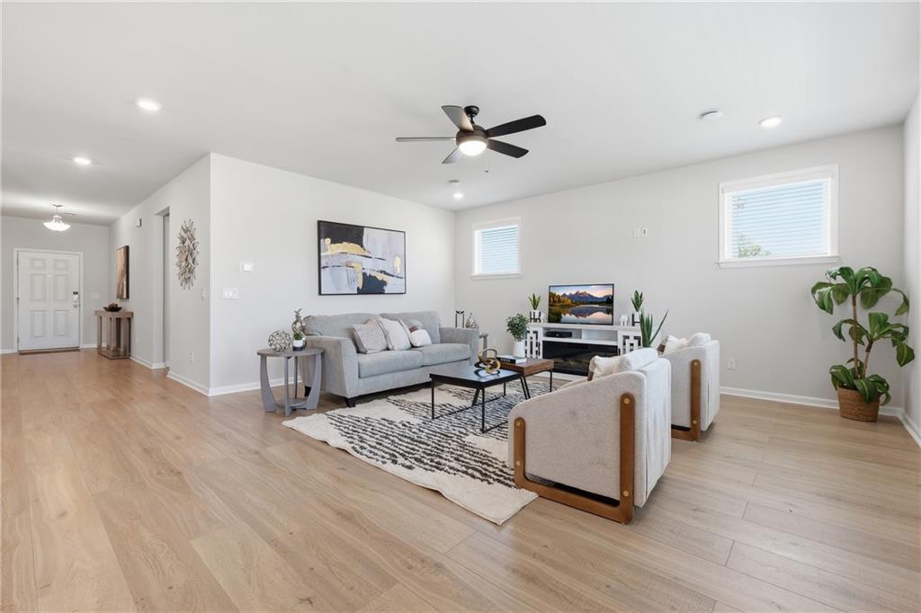 8820 Shipton Circle Ball Ground, GA 30107 - Photo 7 of 40 a living room with furniture and a wooden floor