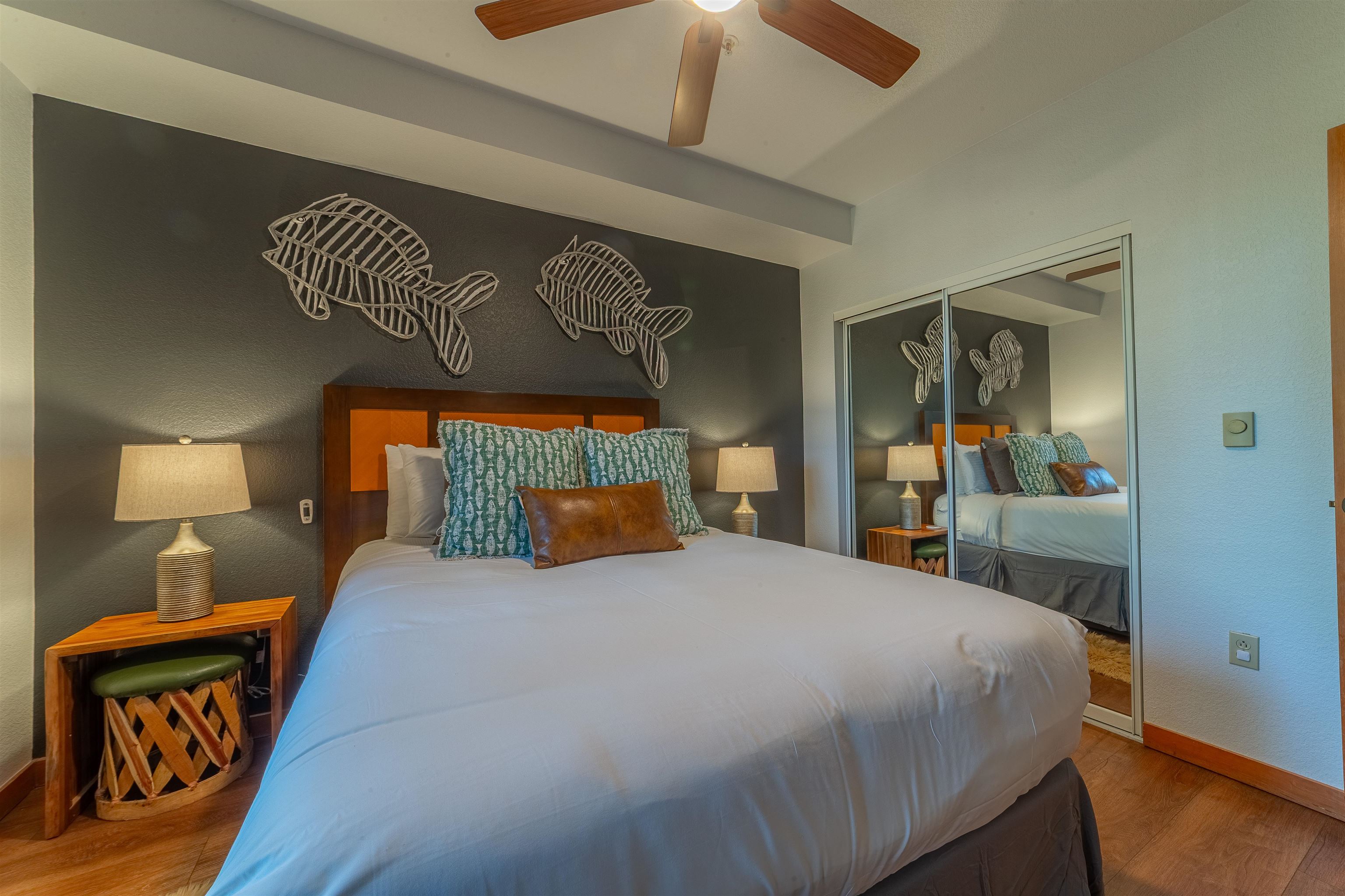 6201 Minaret Road, Unit 2221 Mammoth Lakes, CA 93546 - Photo 24 of 44 Bedroom featuring wood-finish flooring, a wood headboard, a ceiling fan, and mirrored closet doors