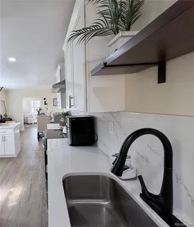 a kitchen with a microwave a stove and white cabinets