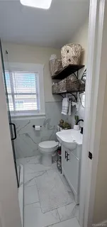 a bathroom with a sink a toilet and bathtub