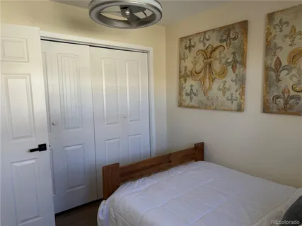 a bedroom with a bed and a painting on the wall