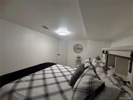 a bedroom with bed and a window