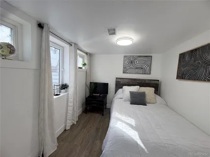 a bedroom with a large bed and a couch