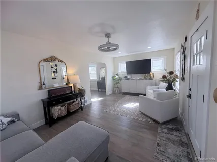 a living room with furniture and a flat screen tv