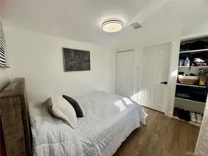 a bedroom with a bed and a view of closet