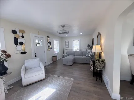 a living room with furniture and a lamp
