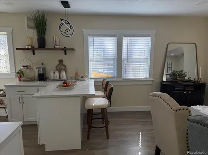 a room with table chairs and windows