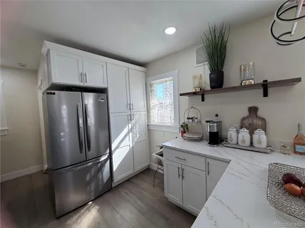 a kitchen with stainless steel appliances a refrigerator sink and cabinets
