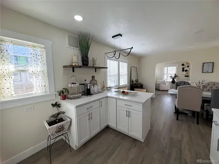 a kitchen with a sink cabinets and wooden floor