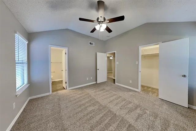 a view of a livingroom with a ceiling fan and window
