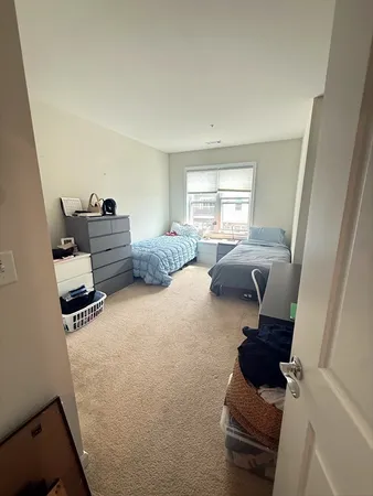 a bedroom with furniture and a window